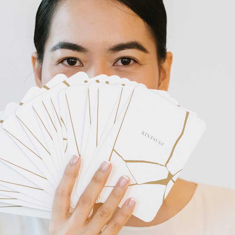 Woman holding Kintsugi intention cards