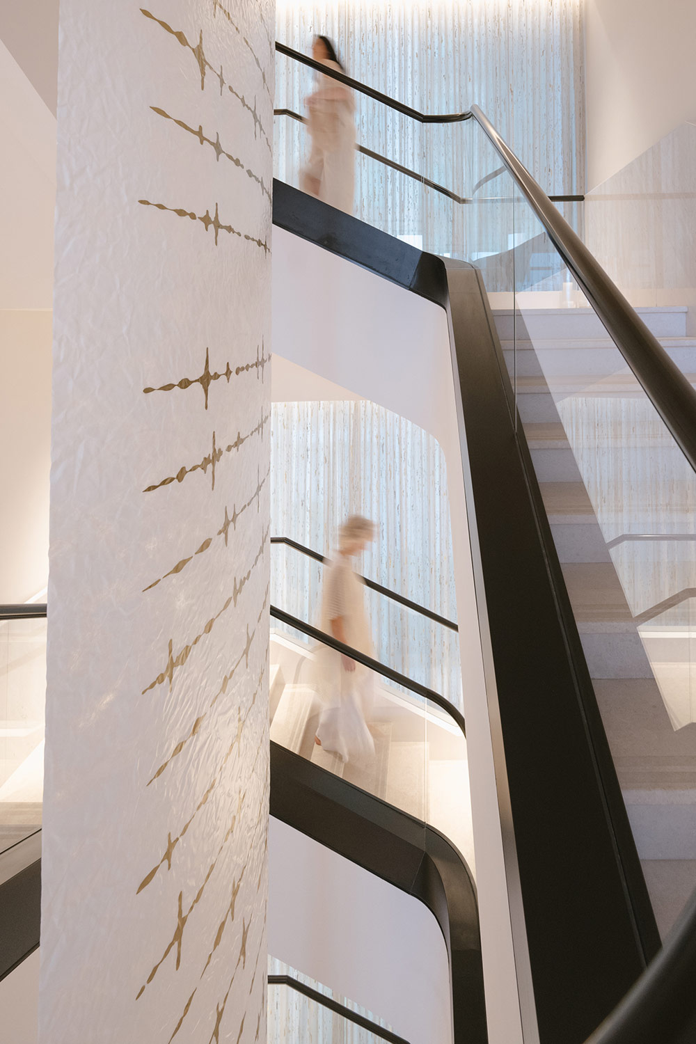 Picture of white stairs and a woman walking down them